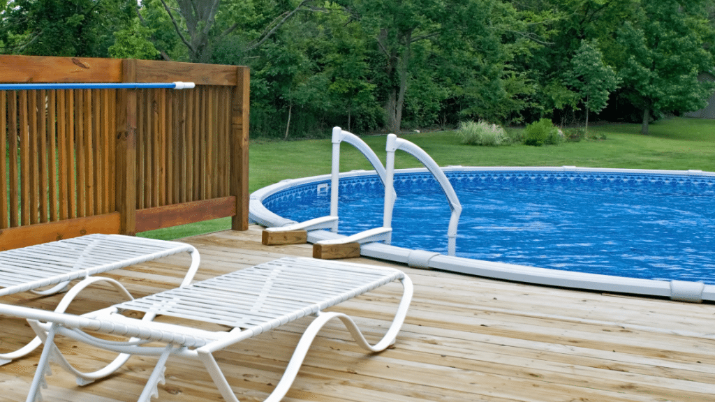 above ground pool with deck and chaise lounges